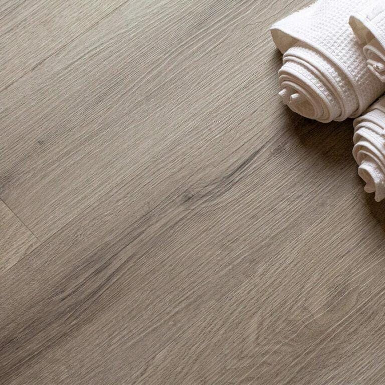 Beige wood-grain laminate flooring with subtle natural texture in brecon dove oak finish