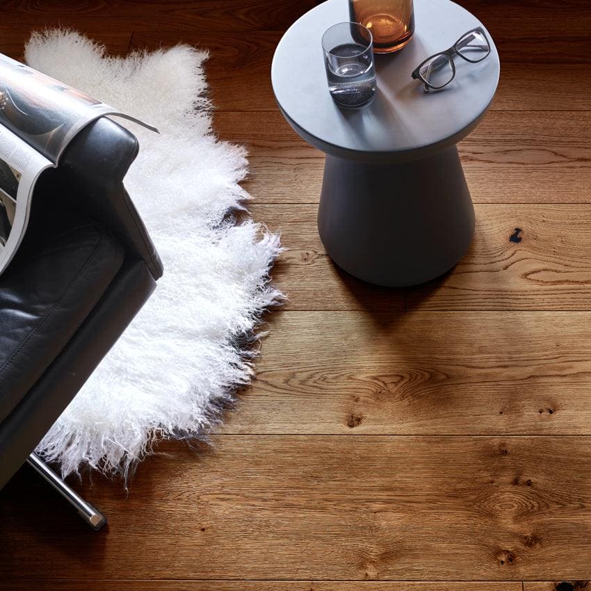 Gray cylindrical side table with flat top surface in chepstow distressed charcoal oak finish