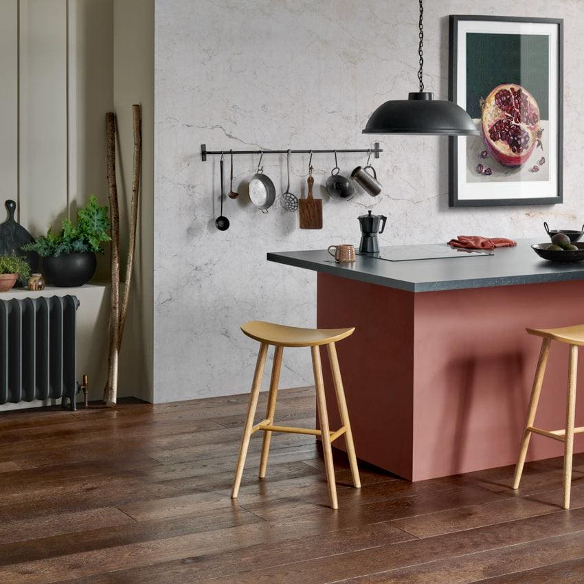 A minimalist wooden bar stool in distressed charcoal oak with slender legs and a smooth light-toned finish