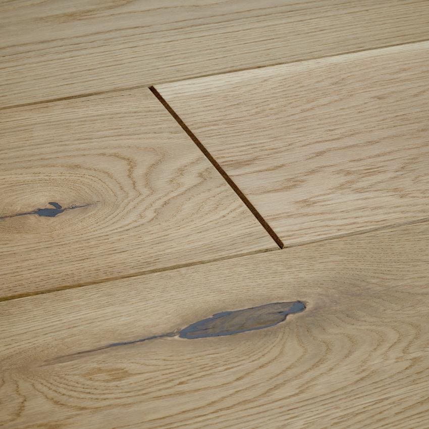 Light-colored chepstow washed oak hardwood floor planks with natural wood grain knots and subtle blue stain accents