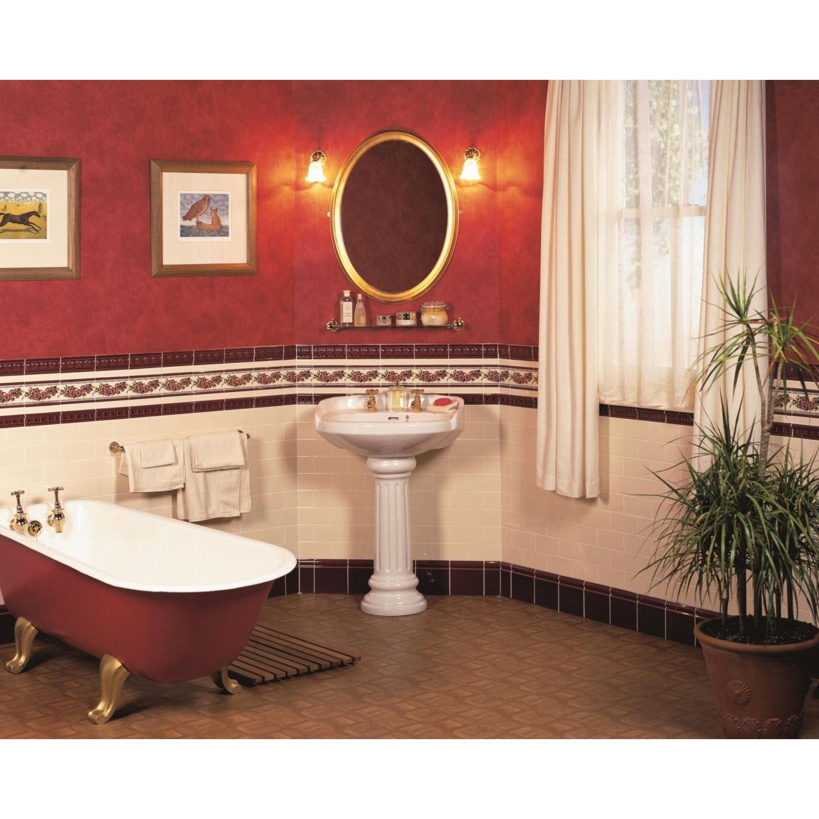 White pedestal sink with corded poppies red classical decorative border on brilliant white and ornate gold-trimmed oval mirror above