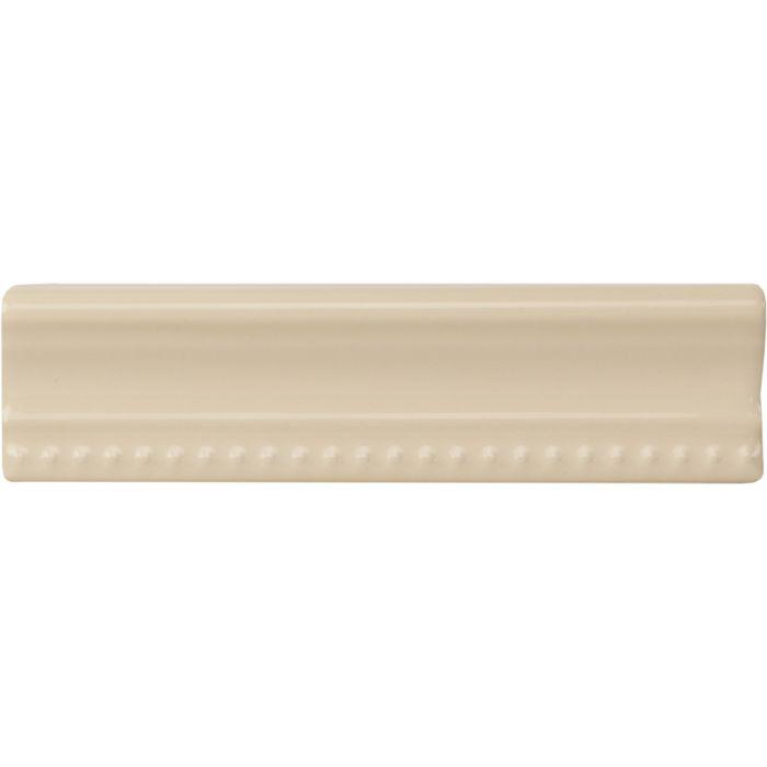 Cream-colored ceramic County White Hogarth moulding baseboard tile with textured beaded edge design
