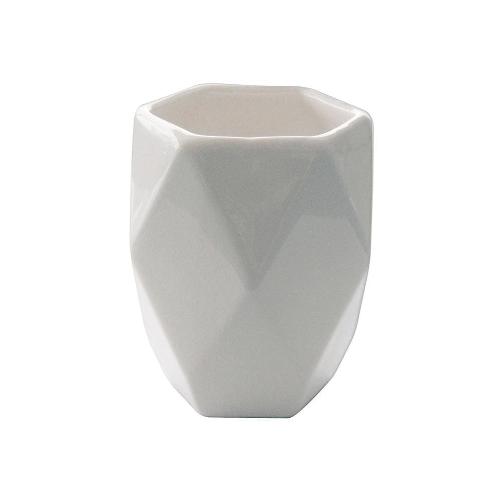 White ceramic toothbrush holder with geometric faceted design from the Dalia tumbler white collection