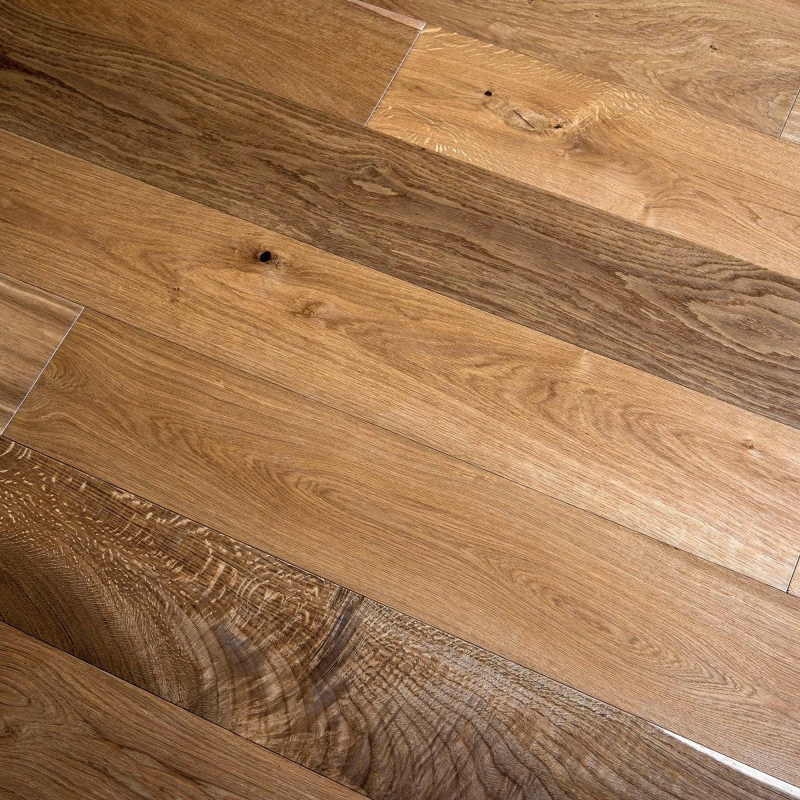 Warm-toned smoked oak hardwood flooring with natural grain patterns and visible knots for elegant interior use