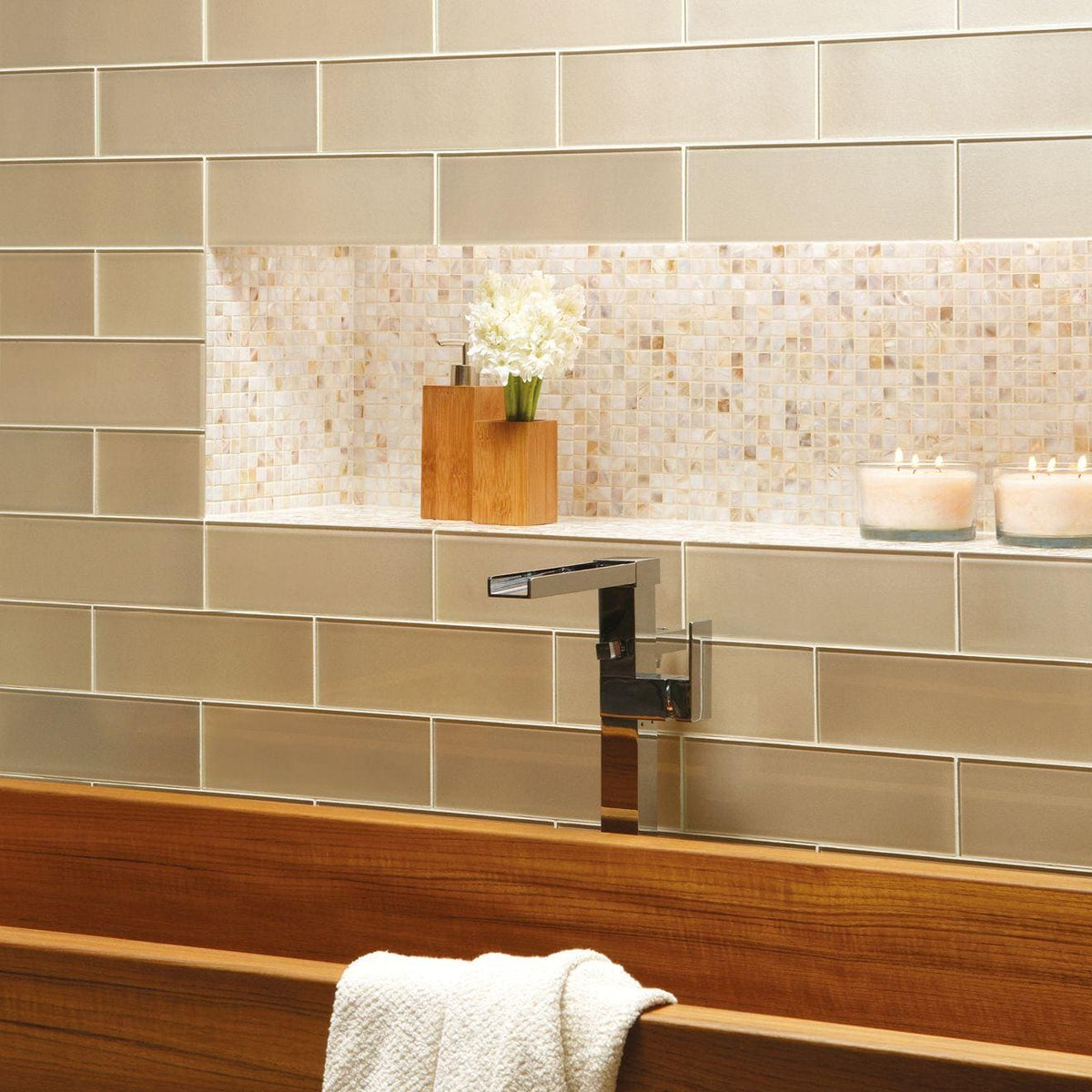 Modern chrome dionysus metallic glass faucet with sleek angular design mounted on tiled bathroom wall