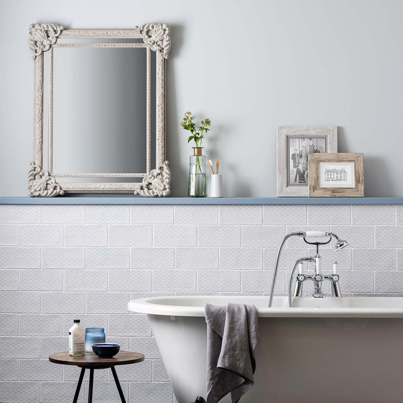 White ornate mirror with intricate floral detailing on fabrique rosaline french blue frame