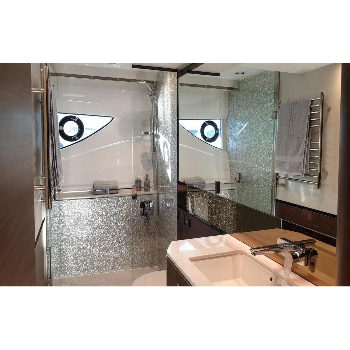 Feature Panel Crackle sparkling silver crackle-glass mosaic panel in a glass shower enclosure with chrome fixtures