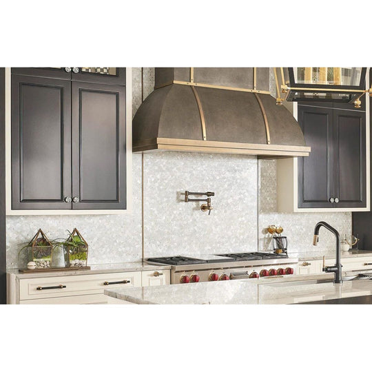 Feature Panel Pearl Drop pearlescent shell mosaic panel with a bronze and brass range hood