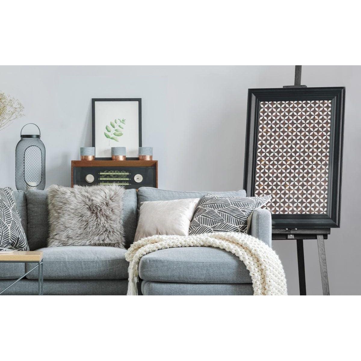 Feature Panel Starlink black and white mother-of-pearl star-pattern panel with a grey upholstered sofa