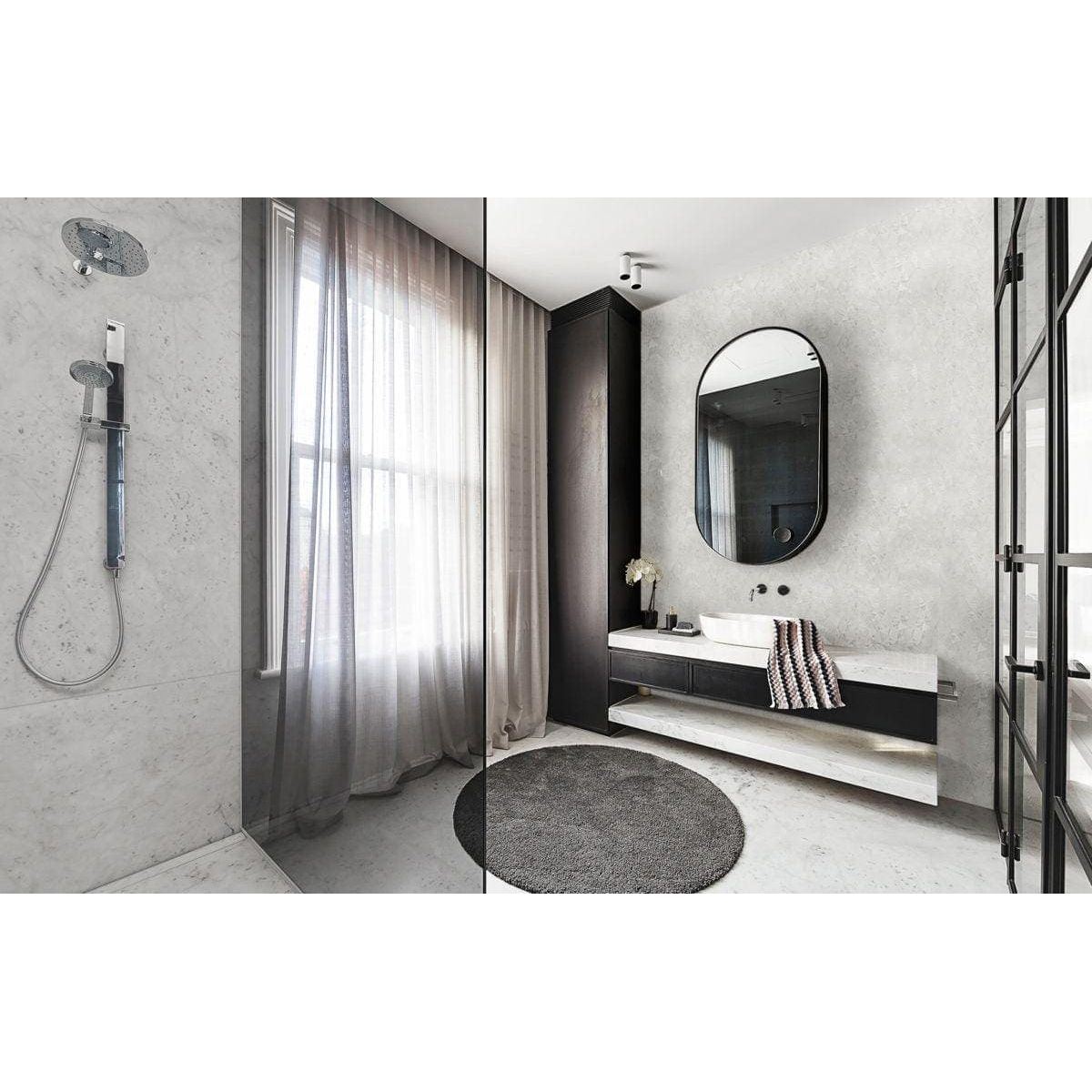 Feature Panel Whisper mother-of-pearl mosaic panel beside a black oval mirror above a vanity