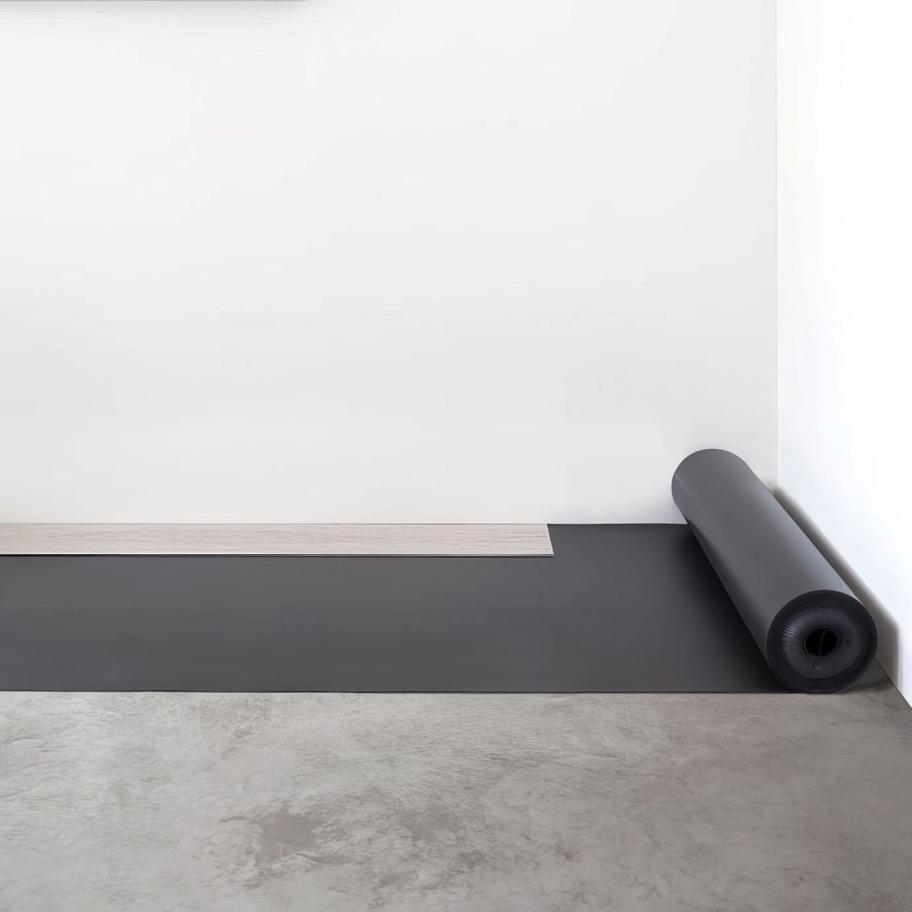 Black yoga mat rolled up in a corner made with floorify comfort underlay for added cushioning and support