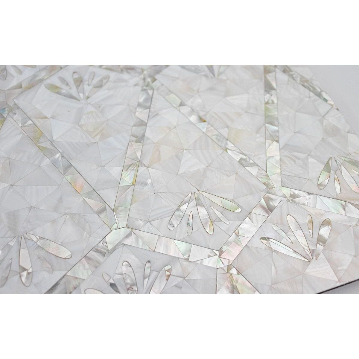 Foxglove mother-of-pearl mosaic with iridescent geometric patterns and delicate floral cutouts on a decorative surface