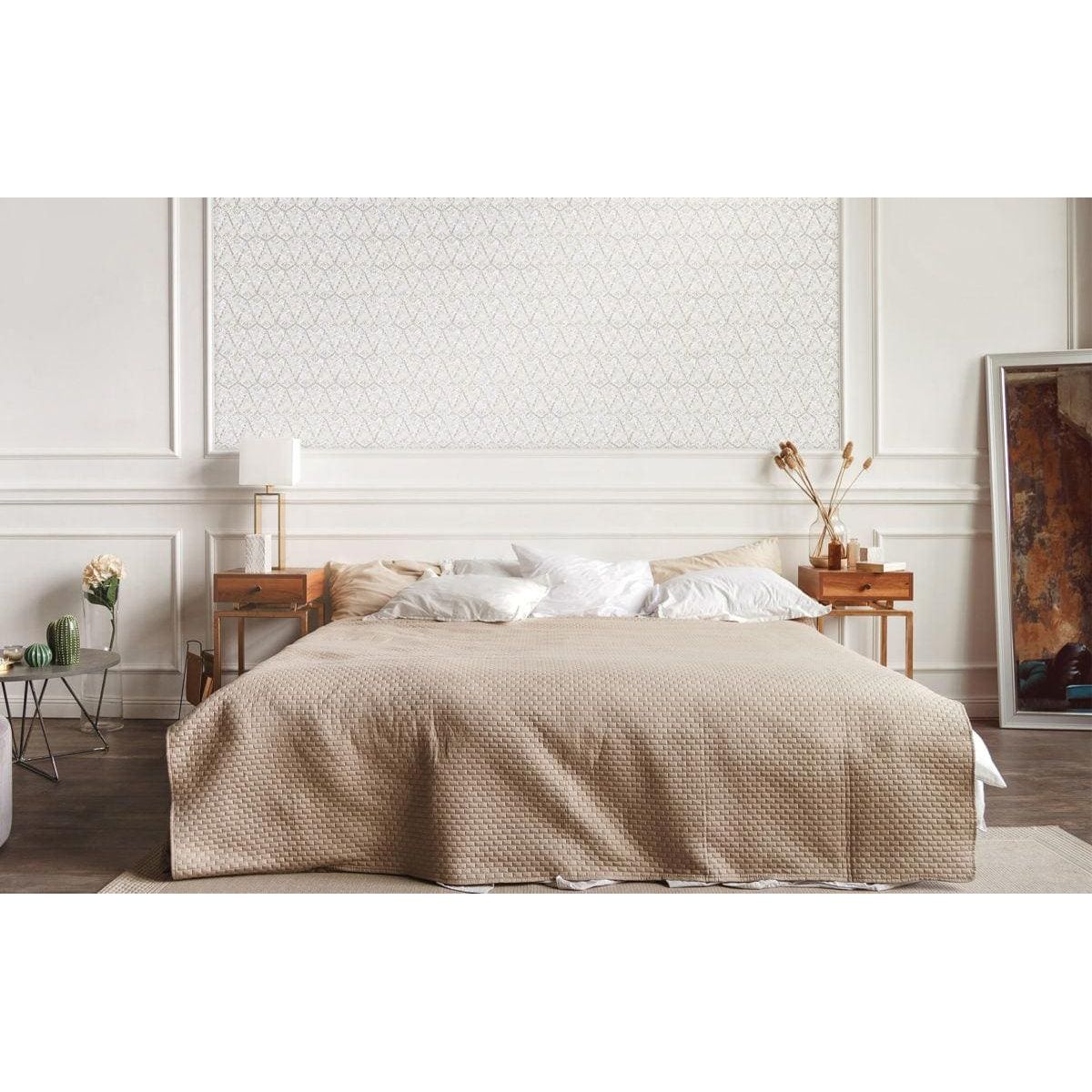 Foxglove mother-of-pearl mosaic panel with a quilted beige bedspread