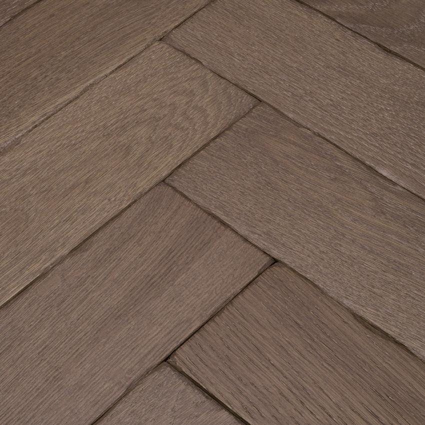 Goodrich barn oak brown hardwood floor planks arranged in a herringbone pattern showcasing oak texture