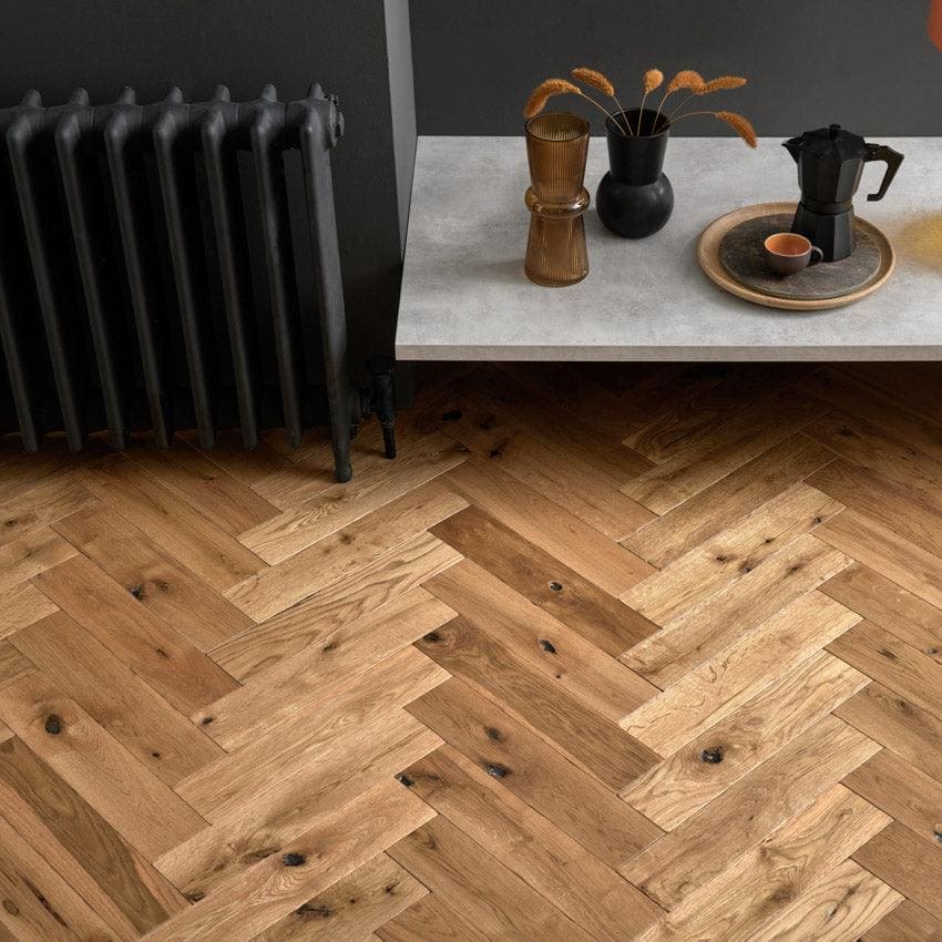 Light brown hardwood floor in a herringbone pattern made from goodrich cathedral oak wood