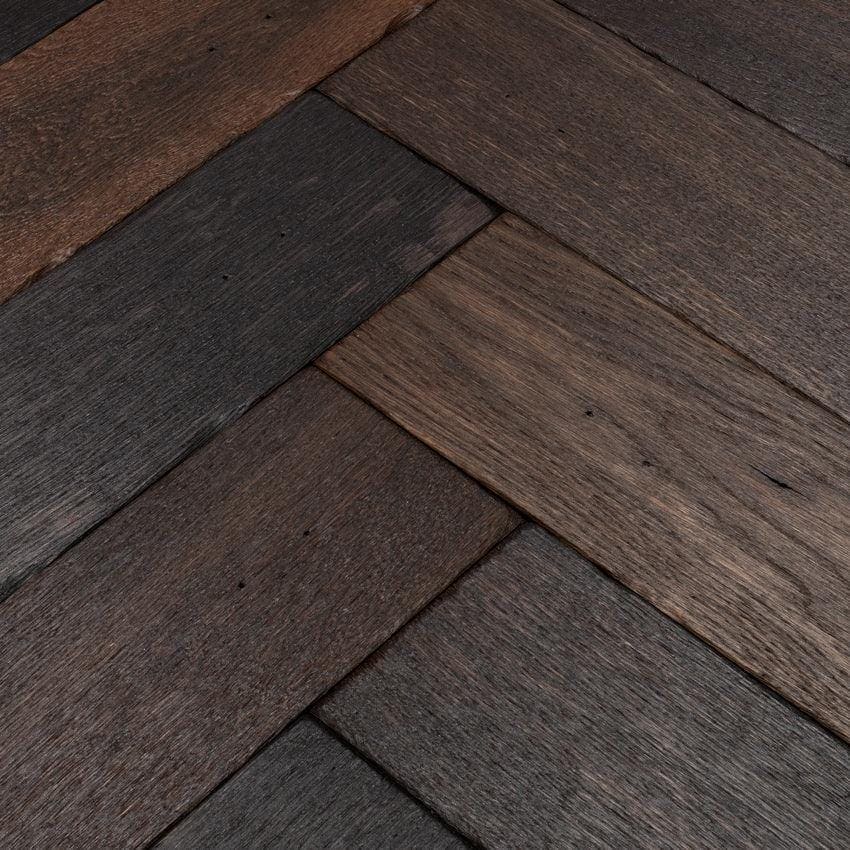 Goodrich charred oak wood planks in dark brown and charcoal arranged in a herringbone pattern