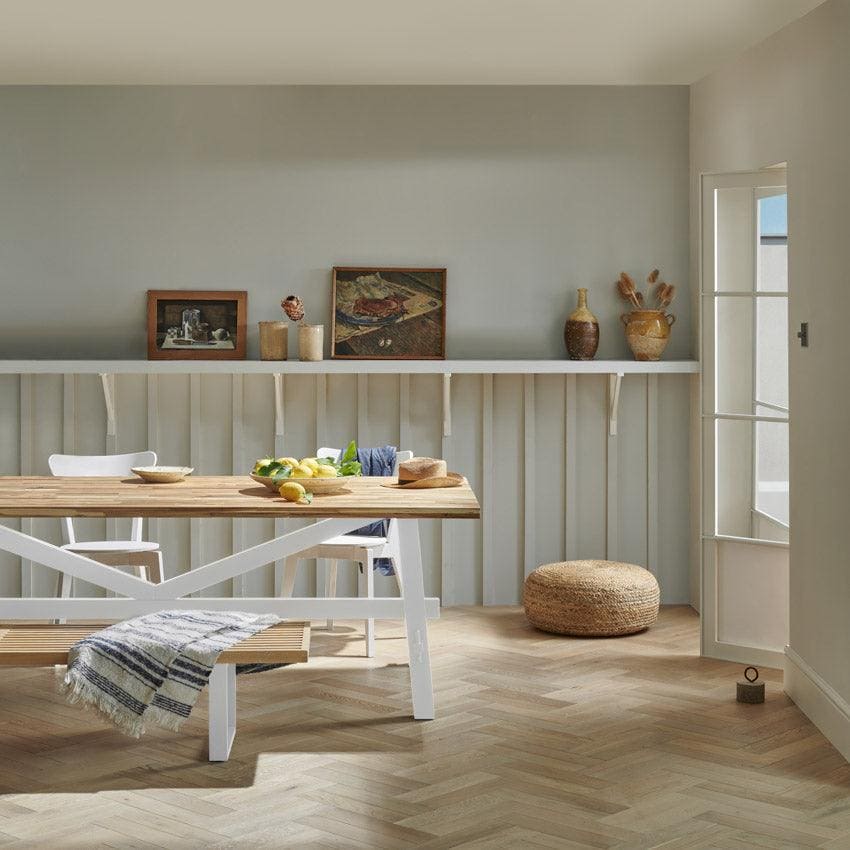 Goodrich ecru oak white wooden dining table with rustic finish and cross-braced legs for farmhouse style dining