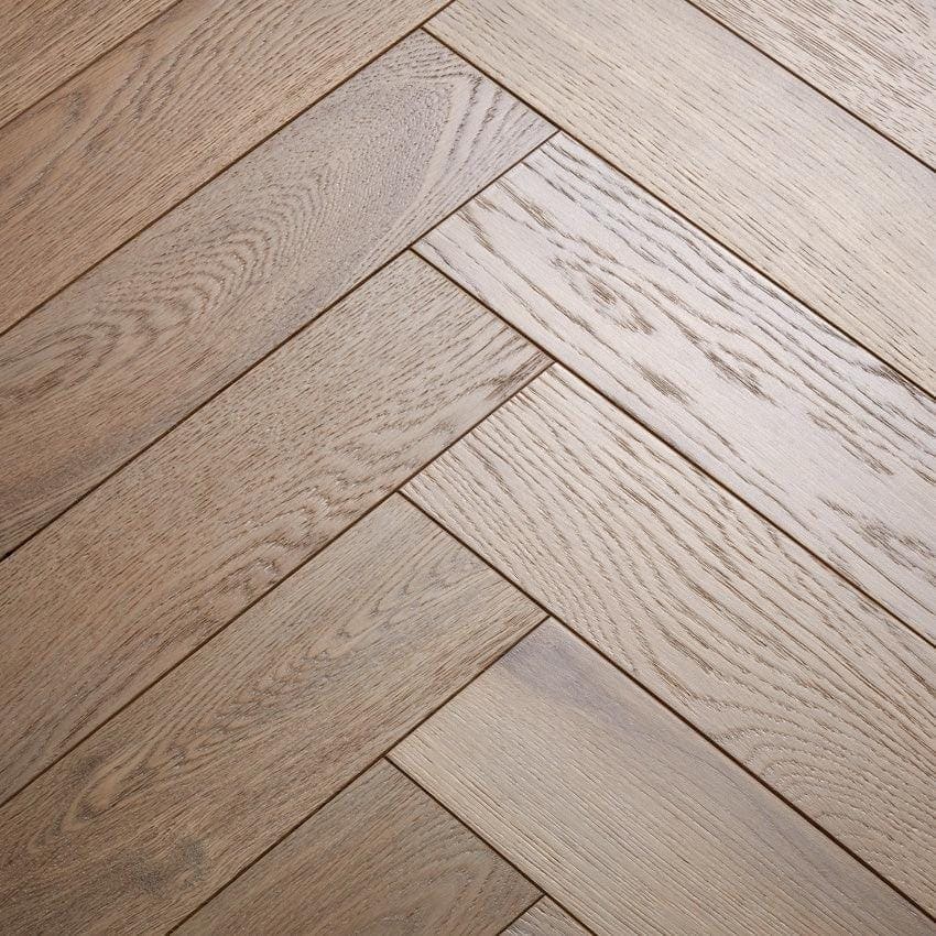 Goodrich Feather Oak light gray oak hardwood floor planks arranged in a herringbone pattern