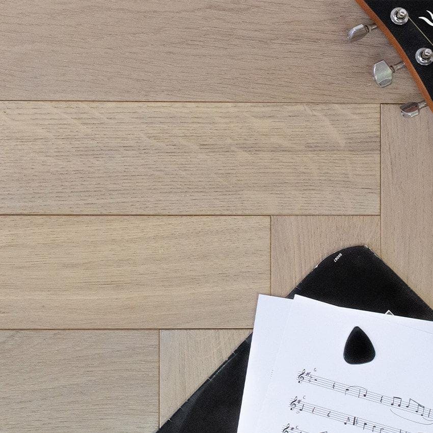 Goodrich Feather Oak light oak wood flooring with a guitar pick on sheet music