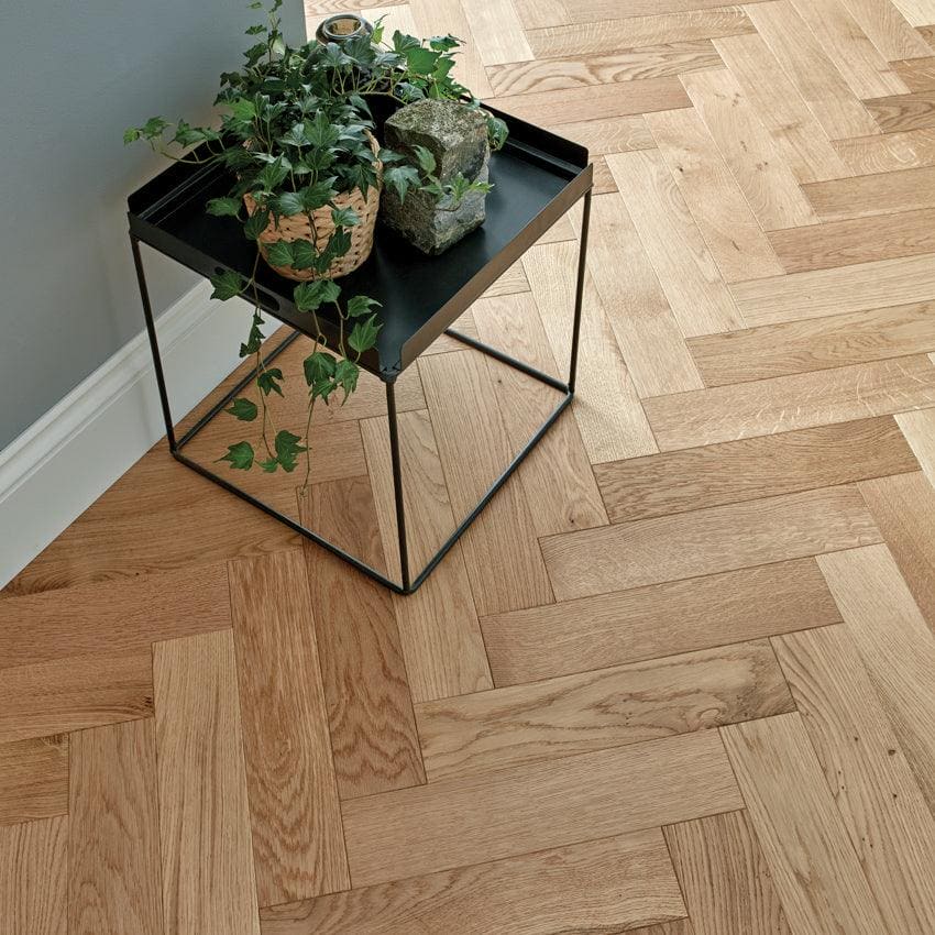Goodrich natural oak black metal-framed side table with matte finish and rectangular top holding potted plants in woven baskets