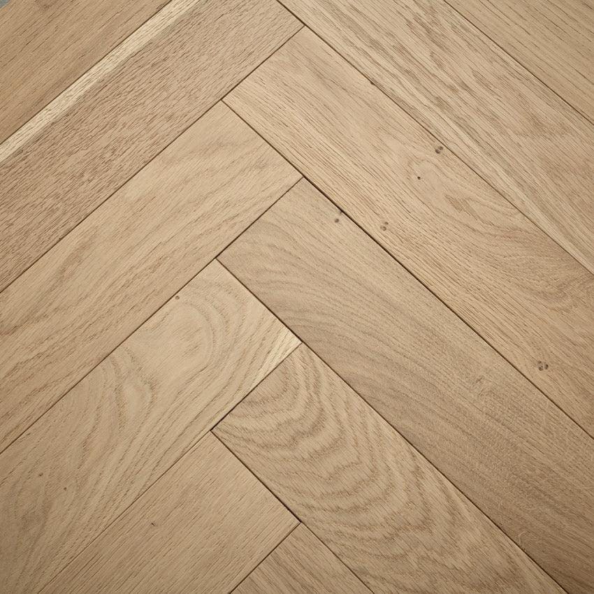 Light oak goodrich raw oak hardwood flooring arranged in a herringbone pattern showcasing natural wood grain