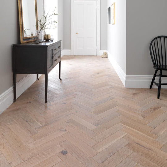 Light-colored Goodrich salted oak hardwood floor with a herringbone pattern showcasing natural wood grain