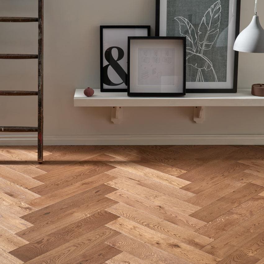Light brown hardwood floor with a herringbone pattern in highclere coffee oak finish