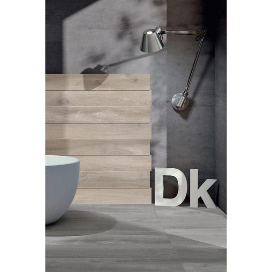 Kingfisher Grey grey wood-effect floor tiles with a silver wall-mounted lamp