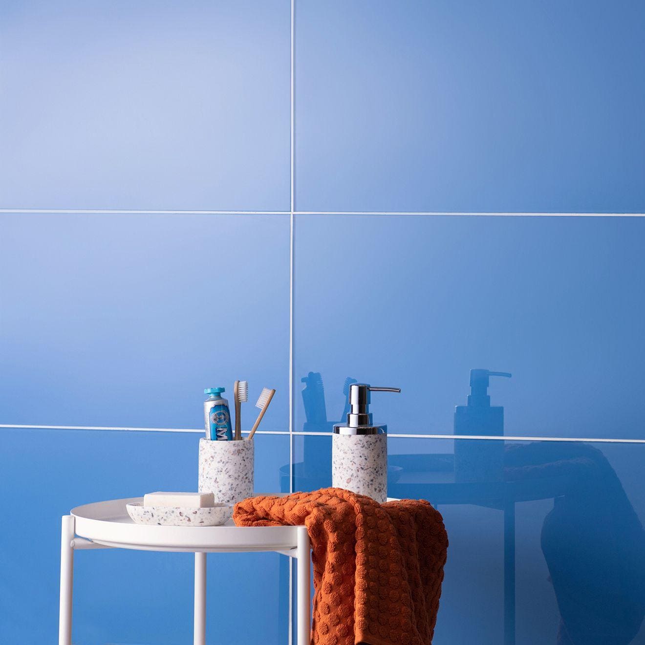 Loire Clear Glass 600 x 300mm blue glass tile with a ceramic toothbrush holder