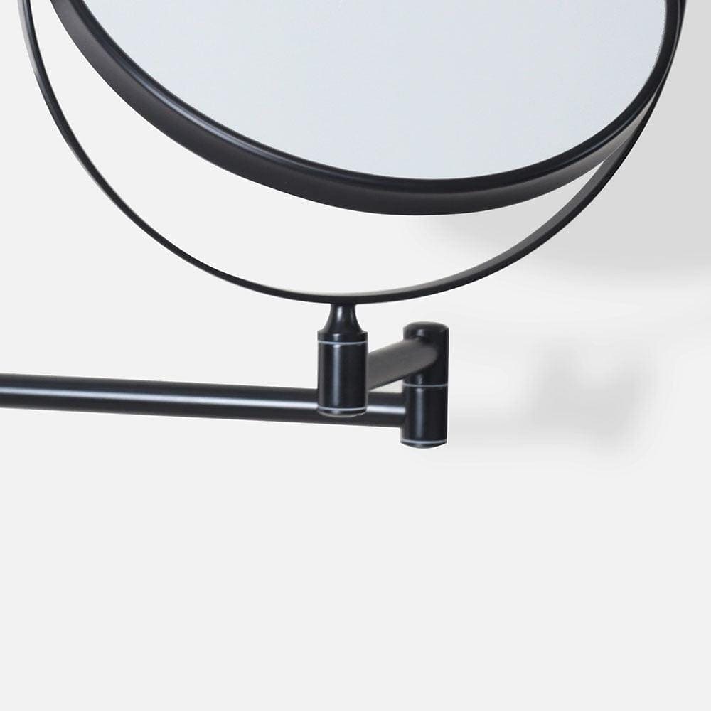 Black circular magnifying wall mirror with 5x magnification and adjustable arm in a sleek minimalist design