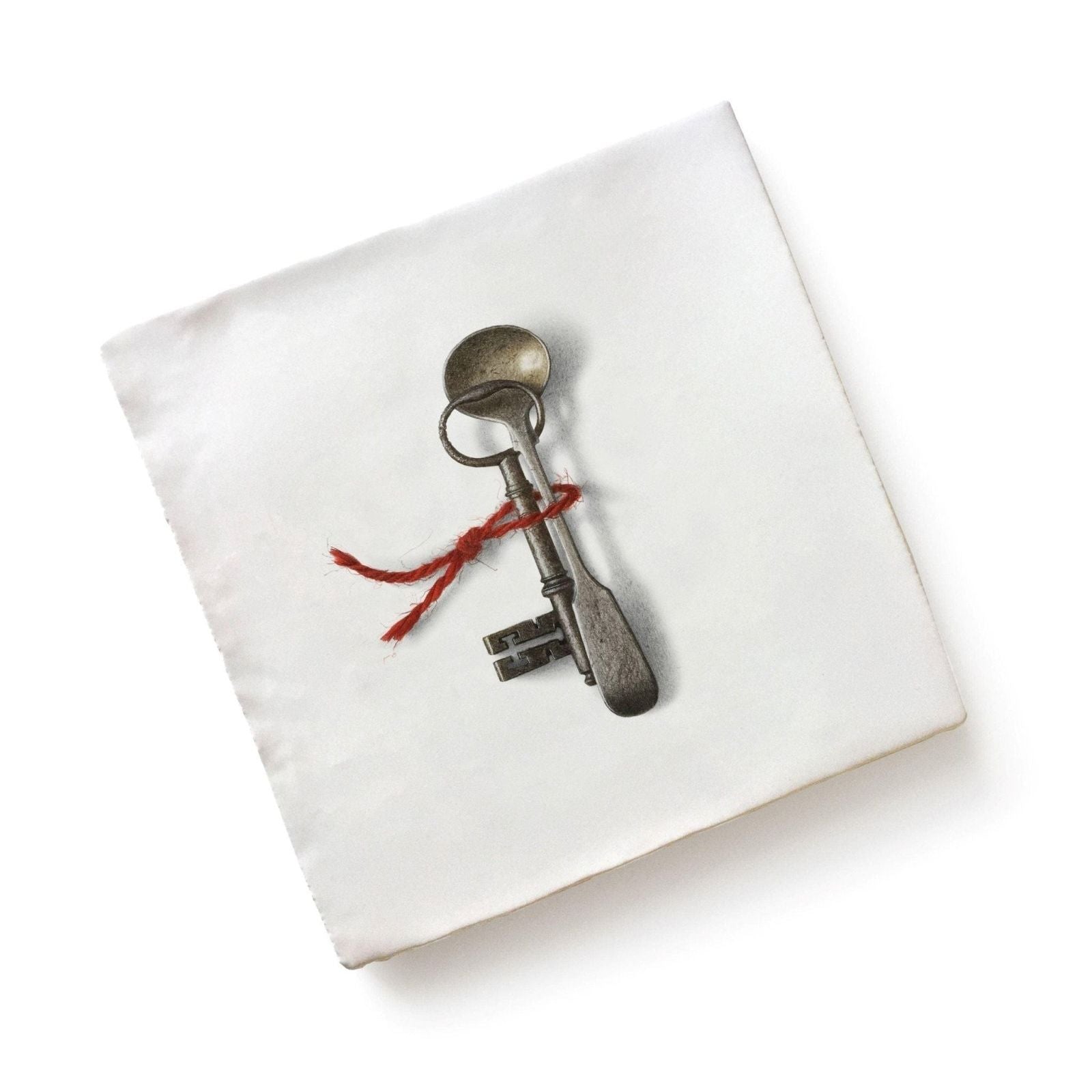 Antique-style metal key with tarnished silver finish tied to old-fashioned spoon by red twine from menagerie ceramic by michael angove