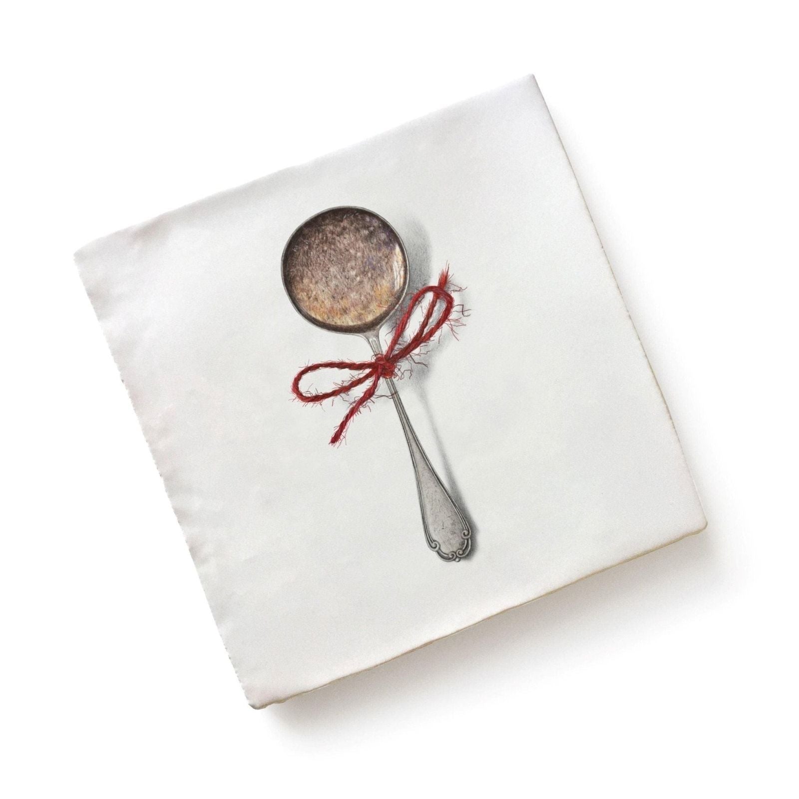 White linen napkin with printed antique silver spoon illustration and red ribbon from menagerie ceramic by michael angove