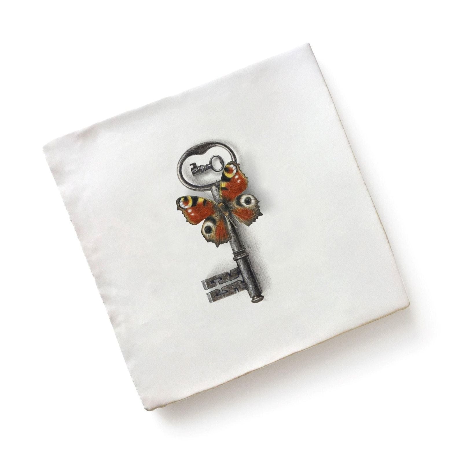 White linen napkin with detailed antique-style key illustration and two orange and black peacock butterflies by michael angove