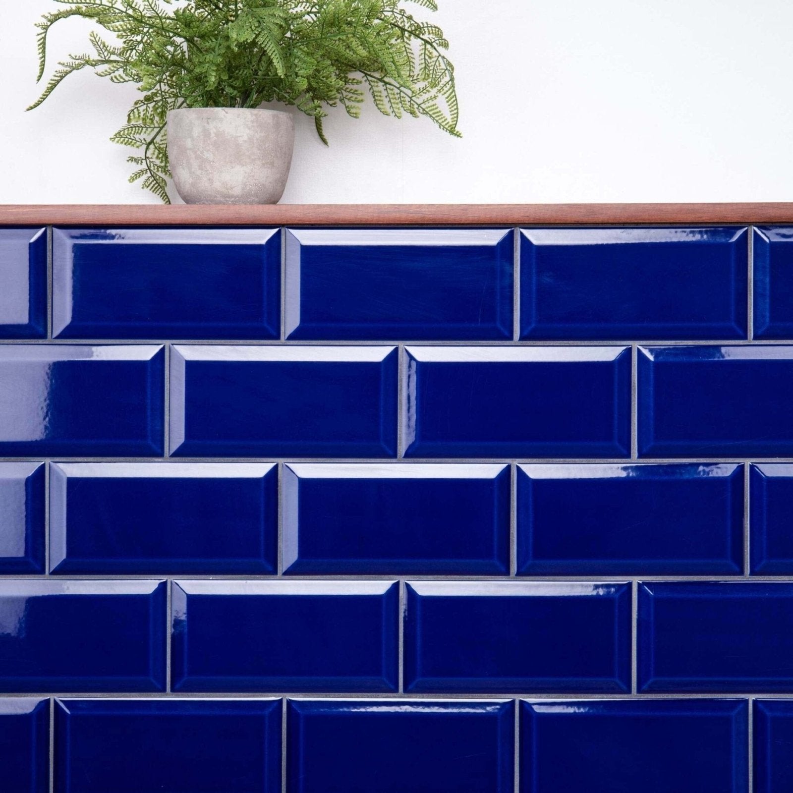 Deep blue glossy subway tiles arranged in a classic brick pattern from metro cobalto gloss collection