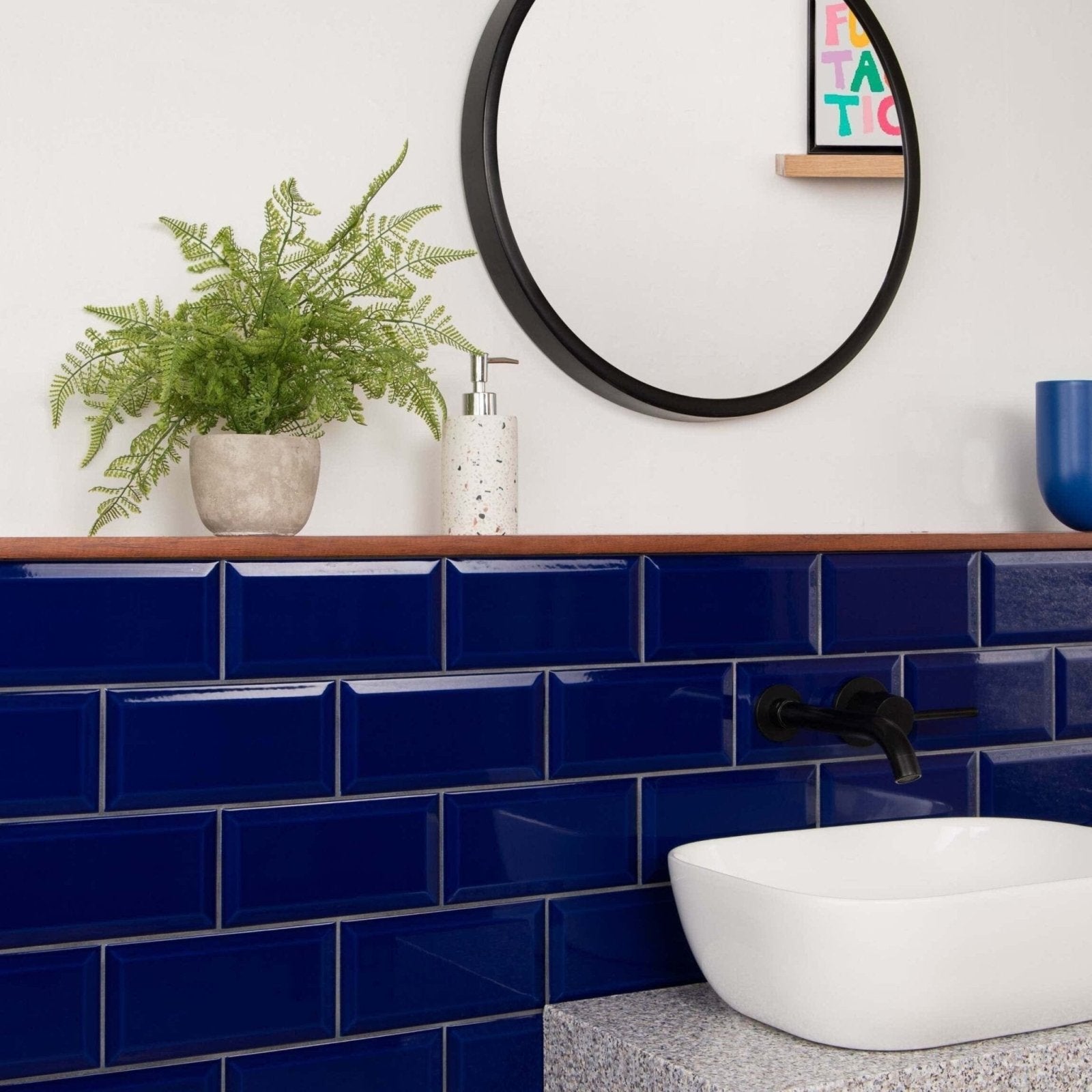 Deep blue metro cobalto gloss subway tiles with a glossy finish lining a bathroom wall