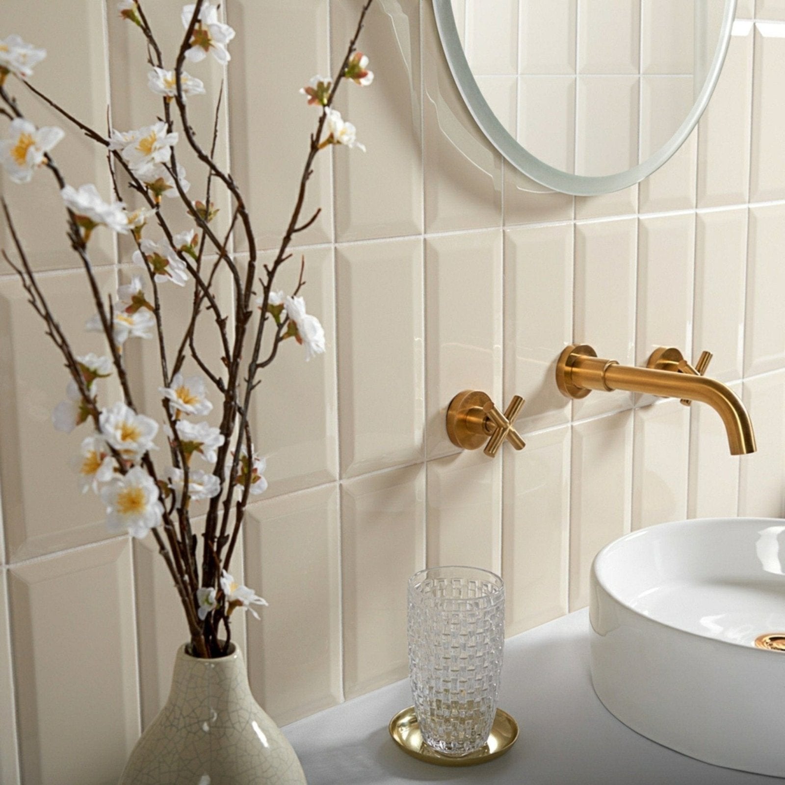 Cream-colored ceramic metro cream gloss vase with subtle texture holding delicate white blossoms