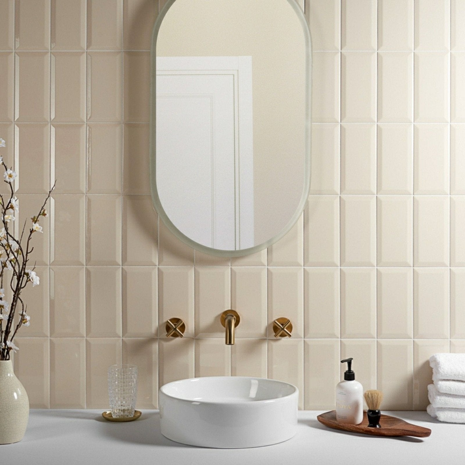 Beige textured tile wall with a subtle geometric pattern in metro cream gloss finish for stylish interiors