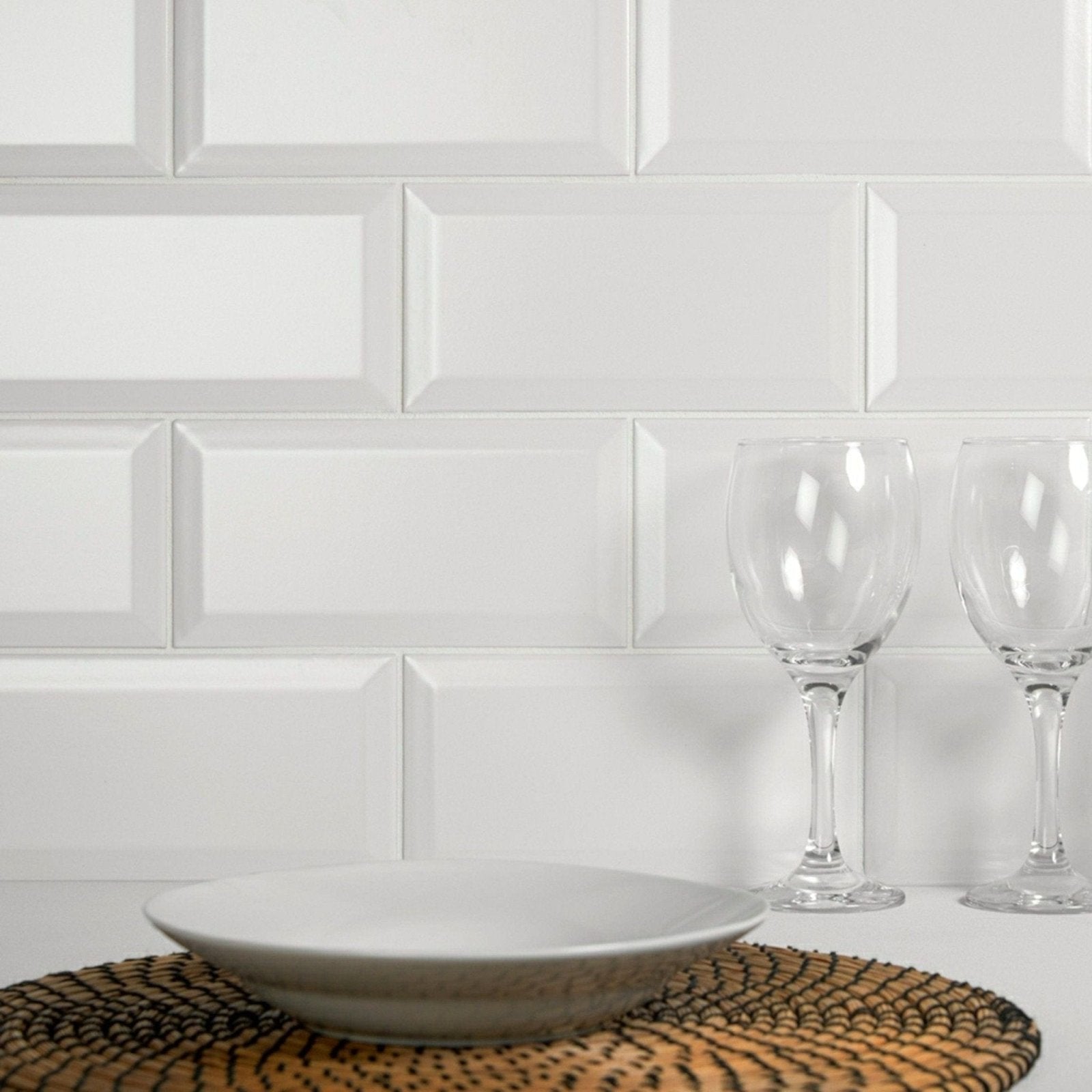 White ceramic bowl with a matte finish resting on a woven placemat in metro matt white collection