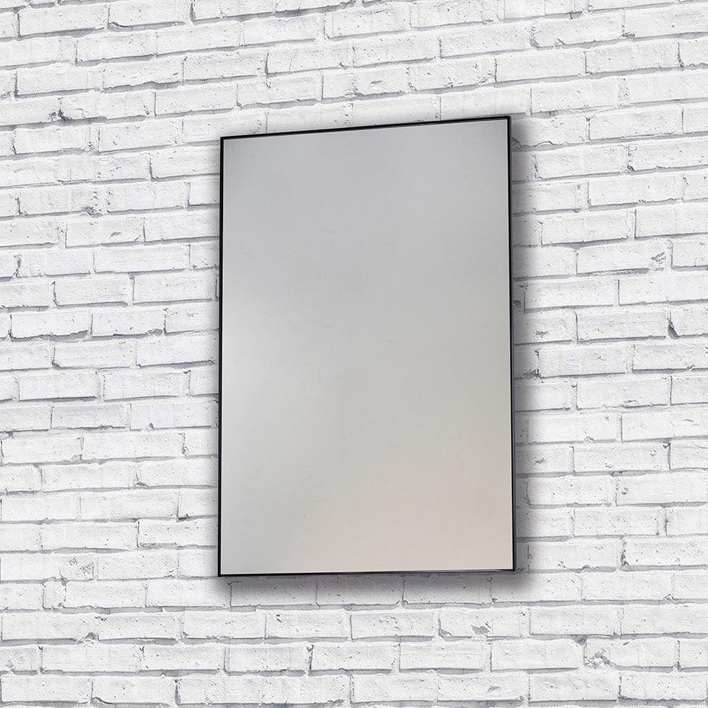 Rectangular metro mirror 60x80cm with a sleek black frame mounted on a white brick wall