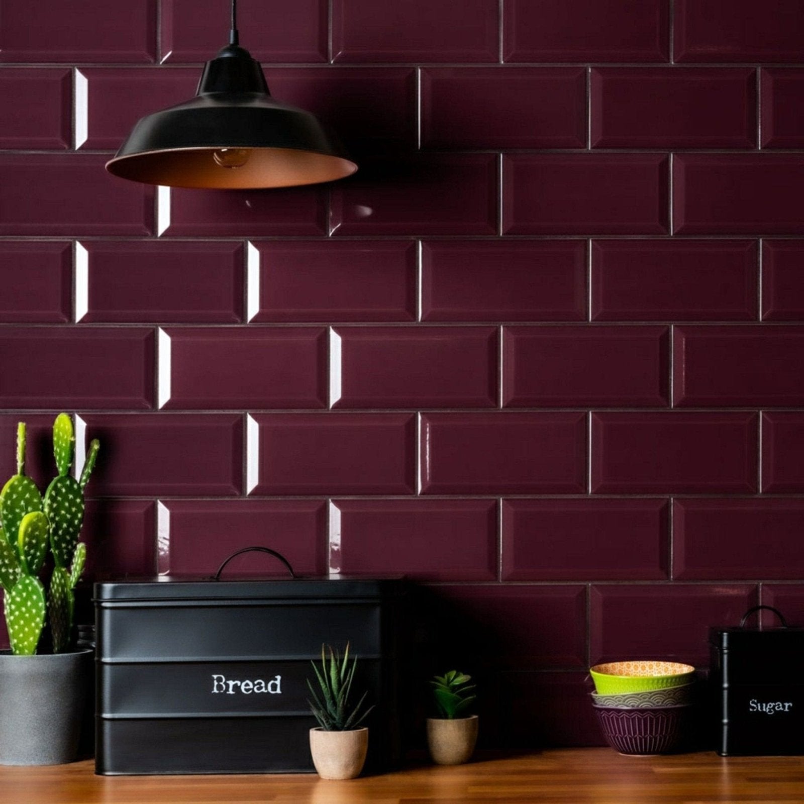 Deep burgundy subway tile backsplash with glossy finish and raised edges from metro plum gloss collection