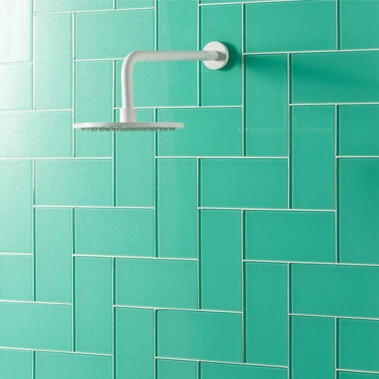 Mississippi Clear Glass 200 x 98mm green glass tile with a white showerhead