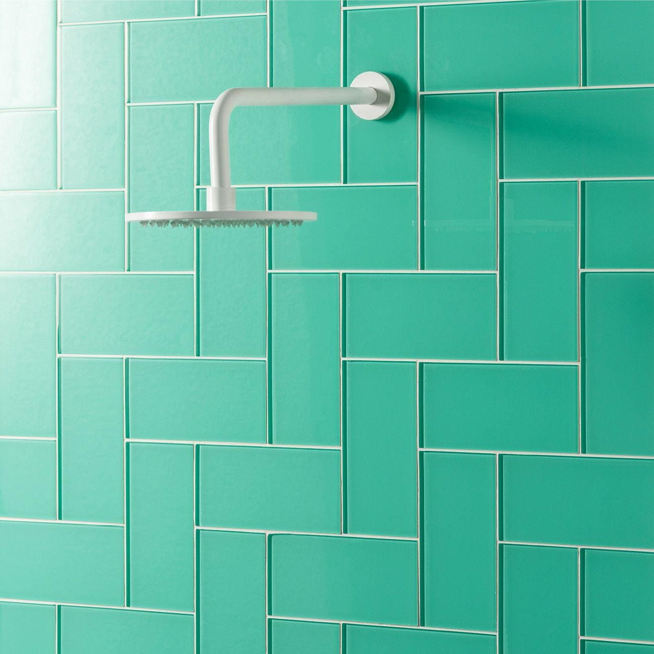 Mississippi Clear Glass 200 x 98mm green glass tile with a white showerhead