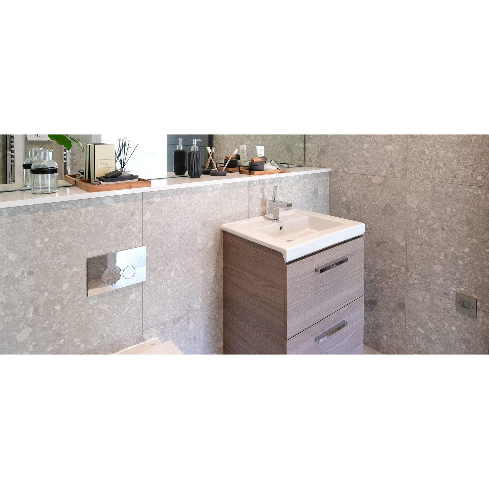Norway Vit Matt light grey terrazzo-effect tiles with a vanity, sink and chrome tap