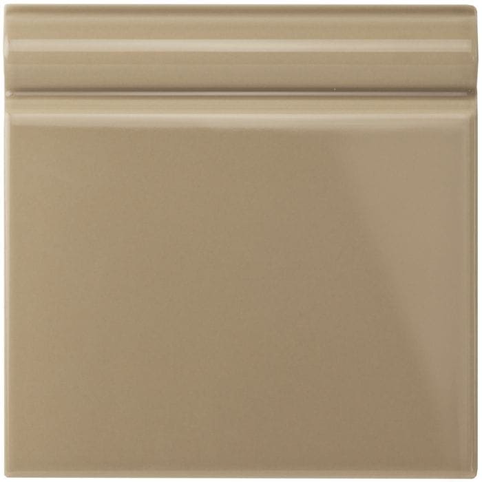 Beige ceramic palladian beige skirting tile with smooth glossy finish and subtle horizontal ridges on top edge