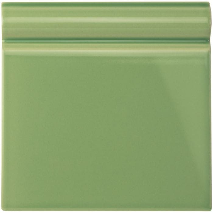 A square glossy sage green ceramic palm green skirting tile with a subtle raised border