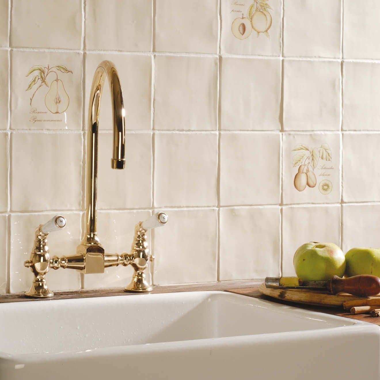 Gold-finished bridge-style kitchen faucet with ornate detailing and matching handles from pear on palomino collection