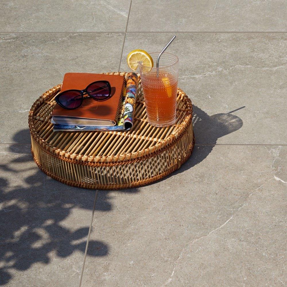 Pulse Carbon Tiles grey stone-effect paving with a woven rattan tray