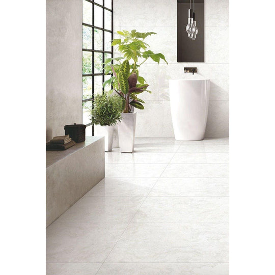 Python Onyx Porcelain Gloss white marble-effect tiles with a pedestal sink
