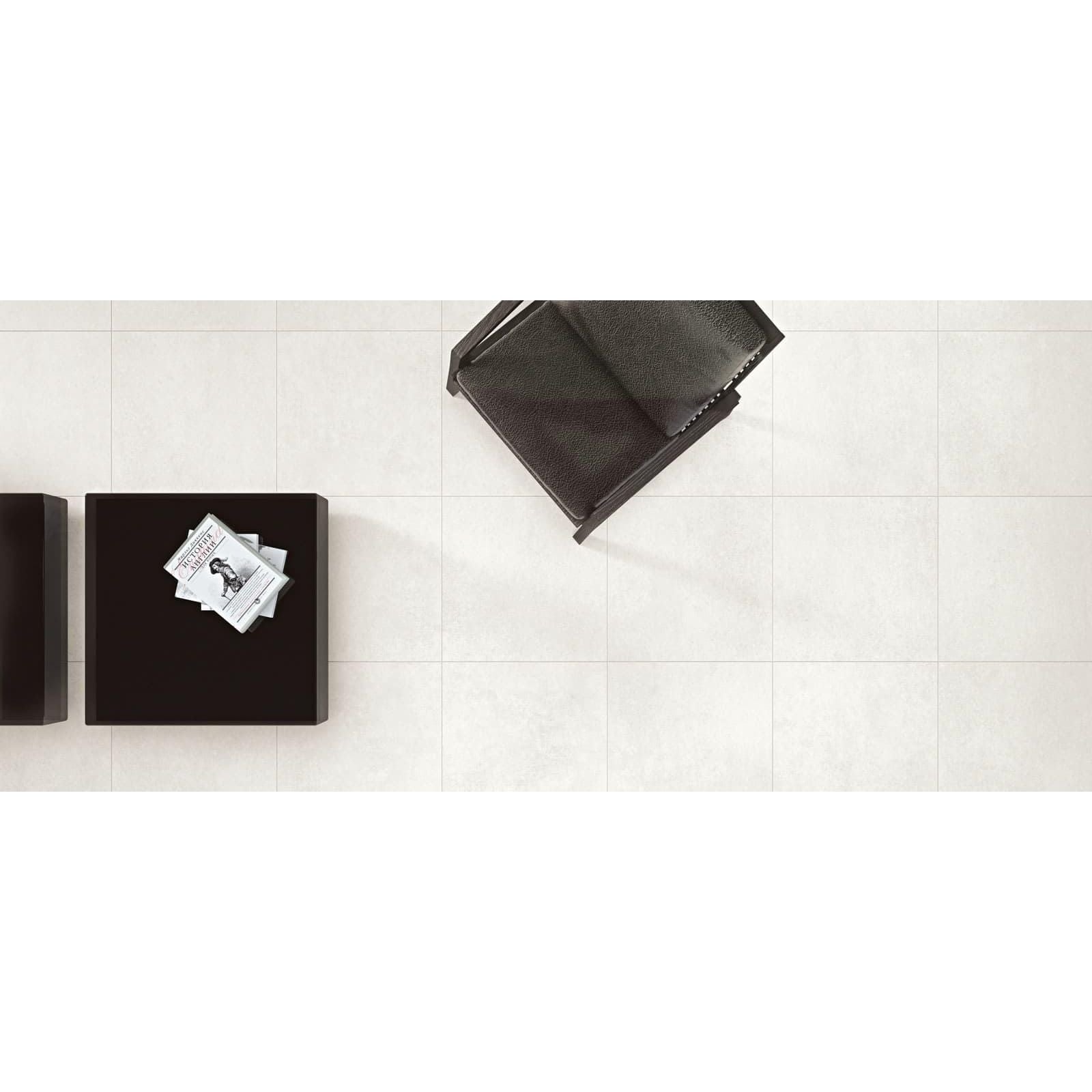 Select Bianco Matt 60 x 60cm cream ceramic tiles with a black leather chair