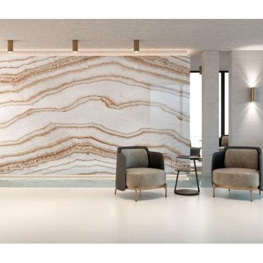 The wall features a large polished marble panel with flowing golden-brown and white veining from Serie Imperial